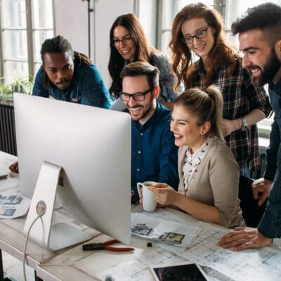 a group of people looking at a computer